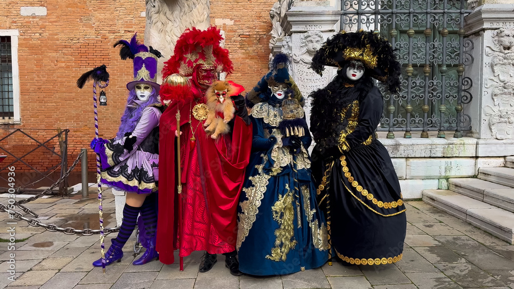 Naklejka premium Venice Carnival. People in Venetian carnival masks and costumes on streets of Venice, Italy, Europe February 10, 2024