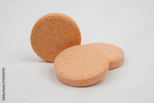 Closeup of chewable vitamin c tablet concept background