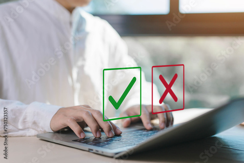 check right and wrong marks on a laptop. concept decide to choose vote. yes or no decisions, and business options for difficult situations in dilemma. true and false symbols agreeing