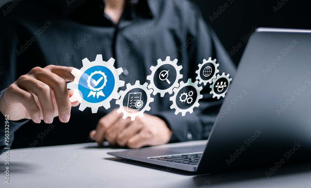 ISO Certification and standardization process concept. Certificate, Approval, Compliance to requirements. Businessman use laptop with quality assurance icon for international standards. ISO Certification and standardization process concept. Certificate, Approval, Compliance to requirements. Businessman use laptop with quality assurance icon for international standards.