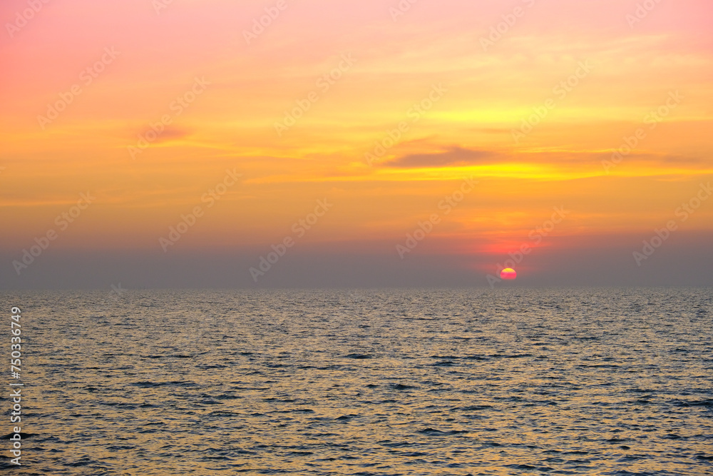 Fototapeta premium Sea view for summer vacation concept Nature of the summer beach and sea with soft sunlight. hitting the sand The sea sparkles against the sunset sky. 