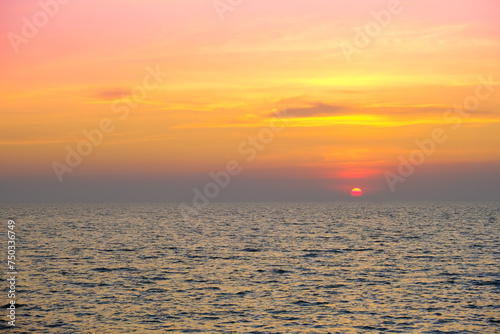 Sea view for summer vacation concept Nature of the summer beach and sea with soft sunlight. hitting the sand The sea sparkles against the sunset sky.  