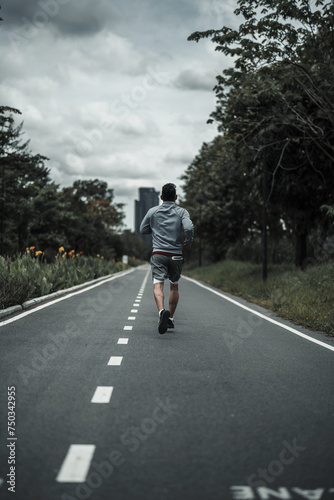 Wallpaper Mural A man  jogging in the city center park cardio workout, running.  Health and Lifestyle in big city life concept. Torontodigital.ca