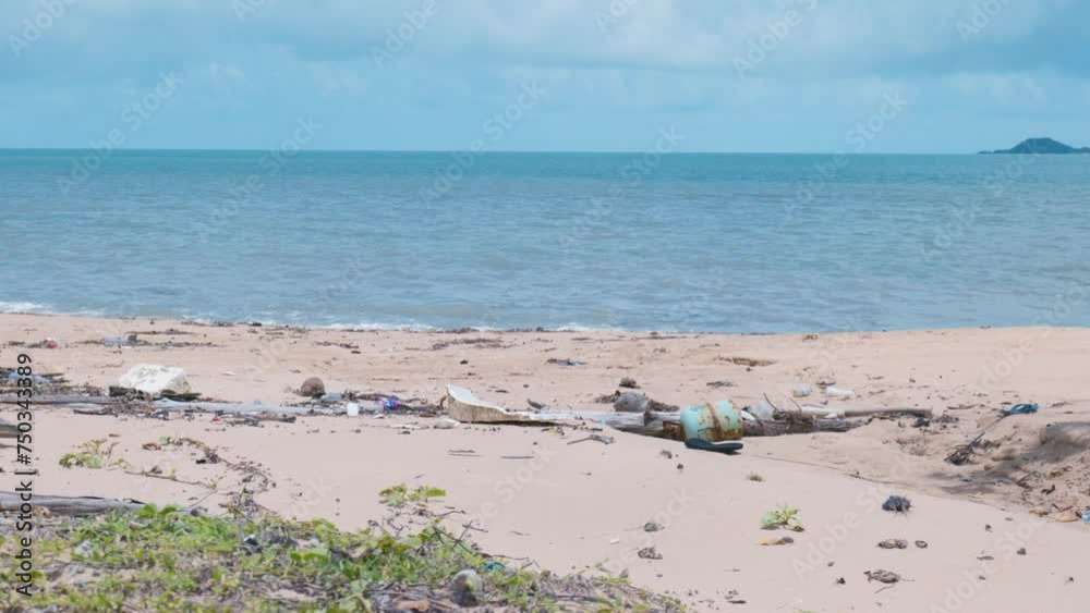 Rubbish washed up on a remote beach in far northern Australia. A steel gas cylinder lies slowly rusting amongst plastic and styrofoam. Fixed camera shot, in 4K Rubbish washed up on a remote beach in far northern Australia. A steel gas cylinder lies slowly rusting amongst plastic and styrofoam. Fixed camera shot, in 4K