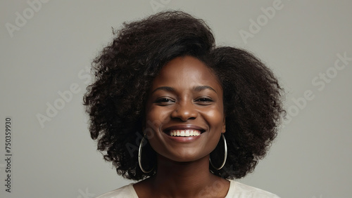 Beauty portrait of african american woman with clean healthy skin on beige background. Smiling beautiful afro girl. Curly black hair