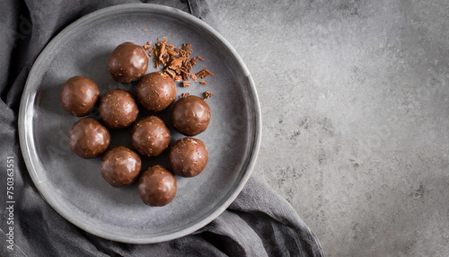 Chocolate truffles or Chocolate balls. top view of Chocolate truffles on grey plate with copy space, dessert, chocolate concept