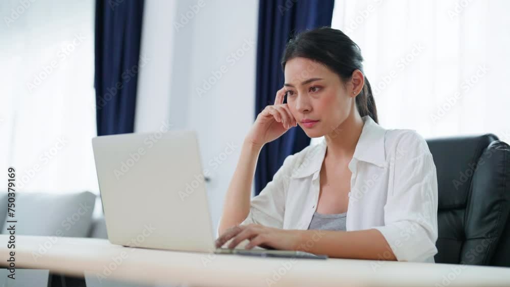 Young asian woman working on computer laptop at home Young asian woman working on computer laptop at home