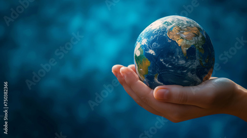 Cradling Our Home: Human Hand Gently Holding a Detailed and Realistic Earth Globe Against a Beautiful Blue Bokeh Background