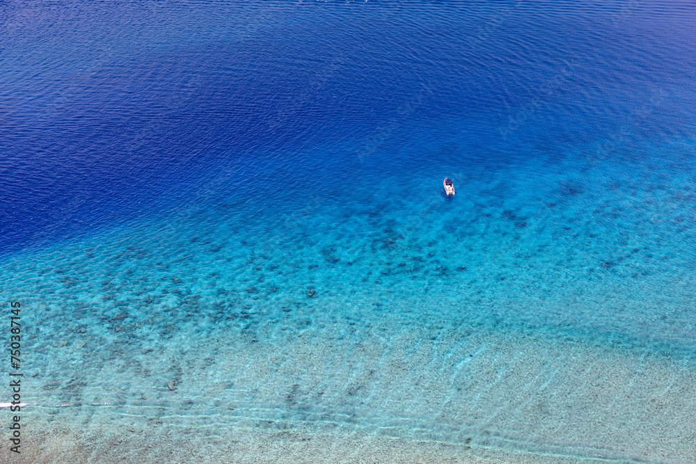 Beauty in nature. Ocean reef aerial view sailing boat next to reef. Bird eye view, water sport theme. Snorkel excursion, recreational dive. Luxury tourism water sport diving activity in Maldives