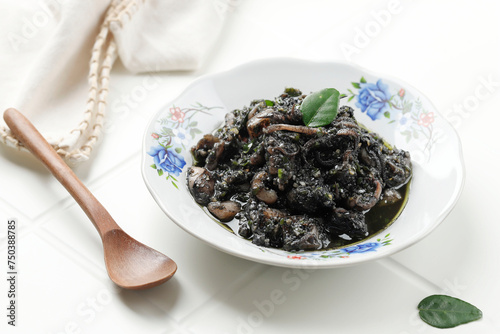 Tumis Cumi Hitam or Stir Fry Squid in Black Ink Sauce. photo