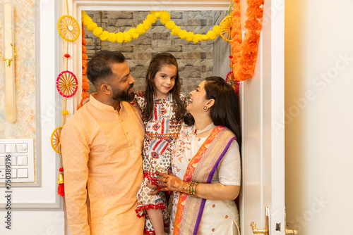Happy indian family of three entering new house for the first time. festival purchase , family relationship concept