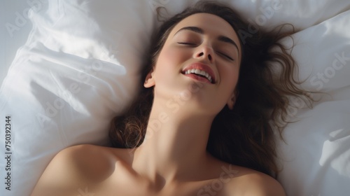 Woman's face during an orgasm in bed. Women's pleasure. A beautiful female with soft skin is enjoying and feels good. 