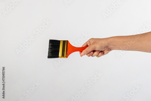 Clean new paint brush in hand isolated on white background.