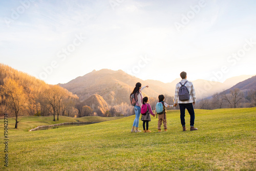 Cheerful young family enjoying the beautiful natural scenery photo