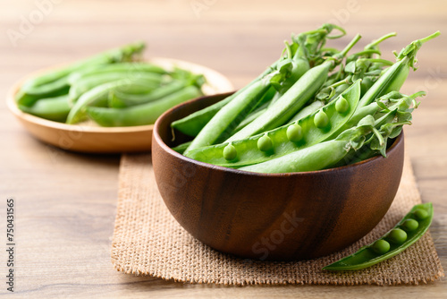 Fresh green pea in wooden bowl, Food ingredient