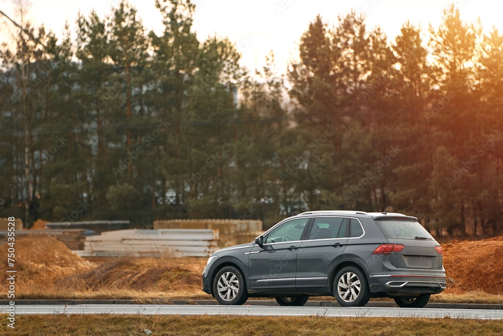 Driving Adventure on an Asphalt Road with the Warmth of Sunset Looming