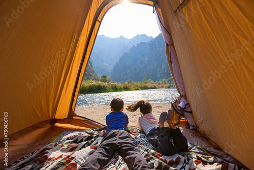 Cute Children looking out from tent