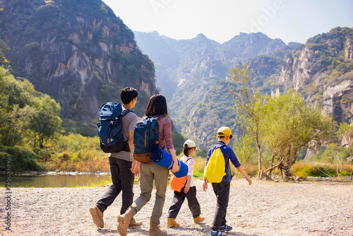 Happy young family hiking outdoors