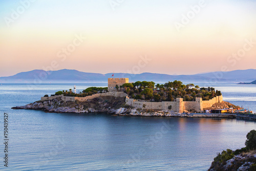 Kushadasi Pigeon Island Castle, (Guvercinada kalesi) at the sunrise and gentle pastel sky at background. Kusadasi, Turkey (Turkiye) photo