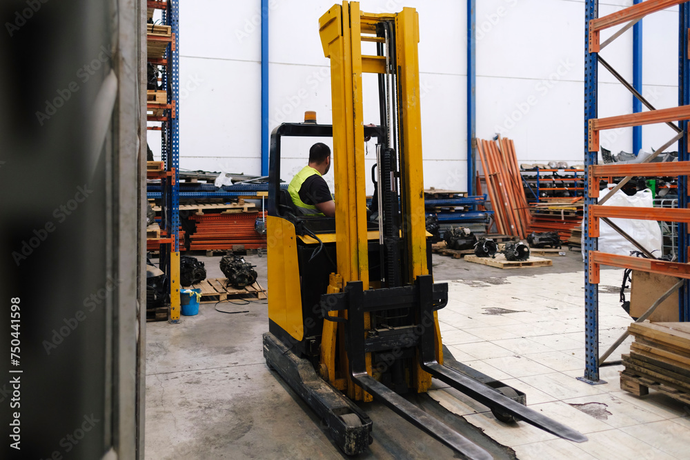 Mechanic sitting in forklift at workshop Mechanic sitting in forklift at workshop