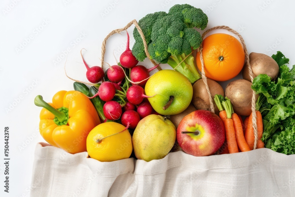 Grocery shopping. Different fresh fruit and vegetables in a textile shopper bag on white background, healthy food from supermarket or delivery concept. Grocery shopping. Different fresh fruit and vegetables in a textile shopper bag on white background, healthy food from supermarket or delivery concept.