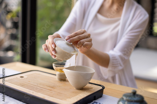 Elegant young woman drinking tea in tea room photo