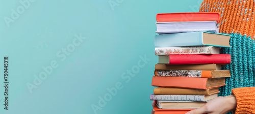 Woman hands holding pile of books 