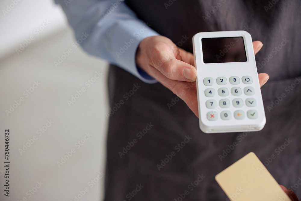 Engineer holding credit card reader in hand at workshop Engineer holding credit card reader in hand at workshop