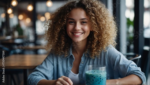 Beautiful curly hair girl sitting at cafe table with blue smoothie, Ai generated 