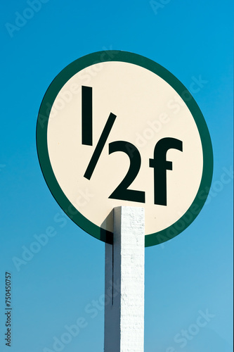 Half Furlong Marker post on a race course isolated against blue sky