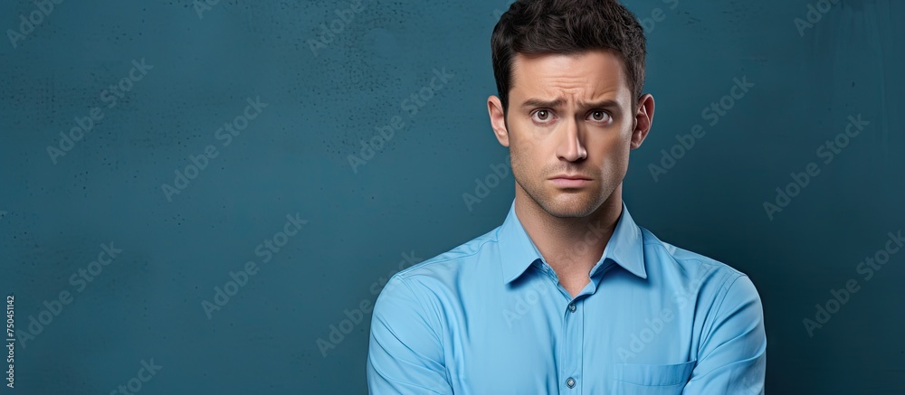 Portrait of a Frustrated Businessman in a Blue Shirt Facing Work Challenges Portrait of a Frustrated Businessman in a Blue Shirt Facing Work Challenges