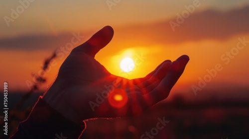 A person's hand holding the sun at sunset. Perfect for inspirational and motivational concepts