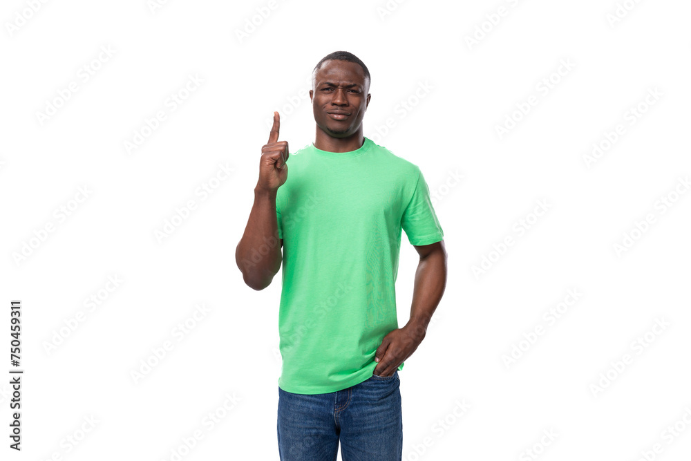 young smart inspired american man dressed in green t-shirt and jeans young smart inspired american man dressed in green t-shirt and jeans
