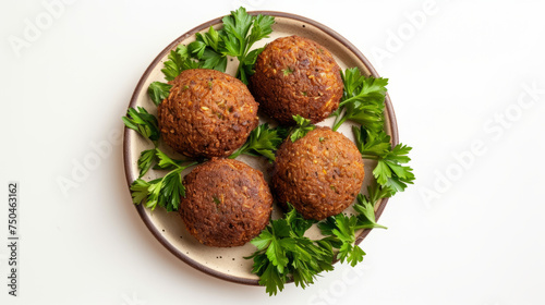 Four balls of falafel on a ceramic plate with a side dish of parsley, top view on a white background. The concept of Middle Eastern cuisine. Design of a vegetarian menu, culinary blog, culinary guide