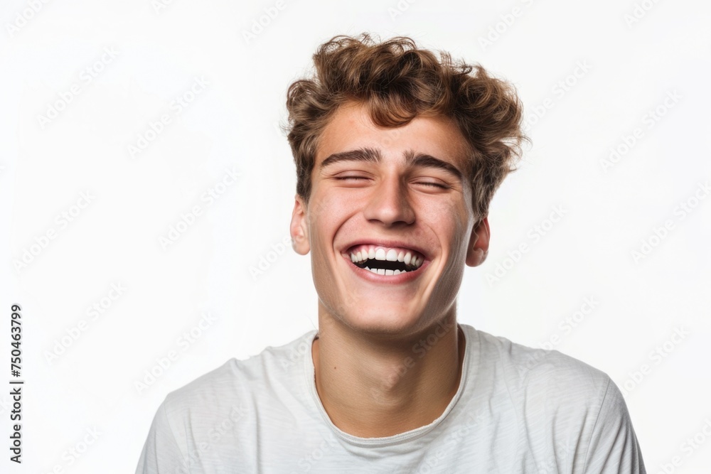 A young man laughing with his eyes closed. Suitable for various projects