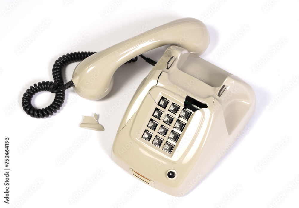 Part of a broken old telephone, phone with dial plate - plastic phone Part of a broken old telephone, phone with dial plate - plastic phone