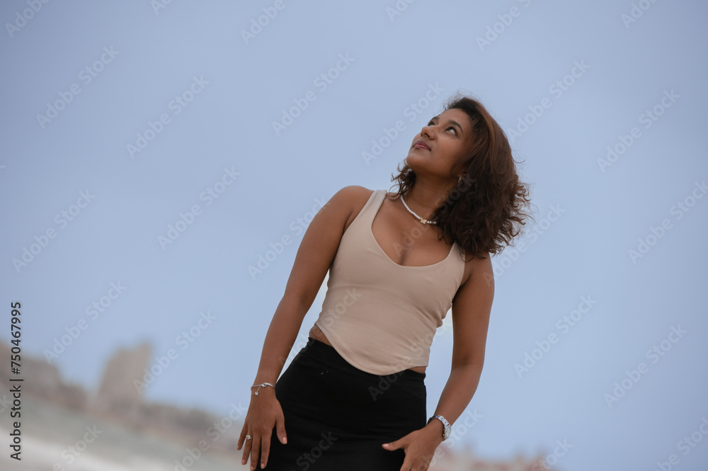 Portrait of young woman looking up to the sky Portrait of young woman looking up to the sky