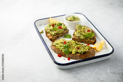 Mashed avocado on toast with lemon and chili pepper 