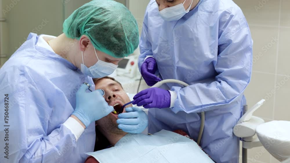 Dentist applies an injection of anesthetic with a syringe in a dental clinic. Dental treatment concept Dentist applies an injection of anesthetic with a syringe in a dental clinic. Dental treatment concept