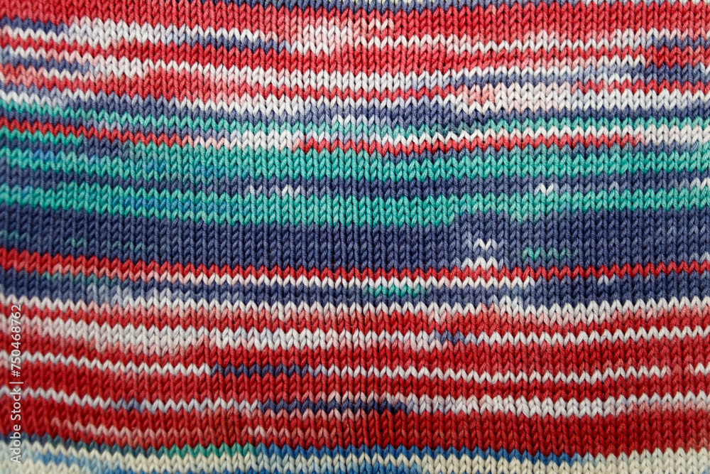knitted fabric from multi-colored melange yarn background. Handwork as a way of relaxation. Spring colors of clothes. knitted fabric from multi-colored melange yarn background. Handwork as a way of relaxation. Spring colors of clothes.