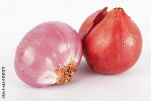 Closeup photo of two shallots with a white background