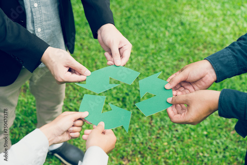People holding recycle symbol against green spring background. Earth day holiday concept.