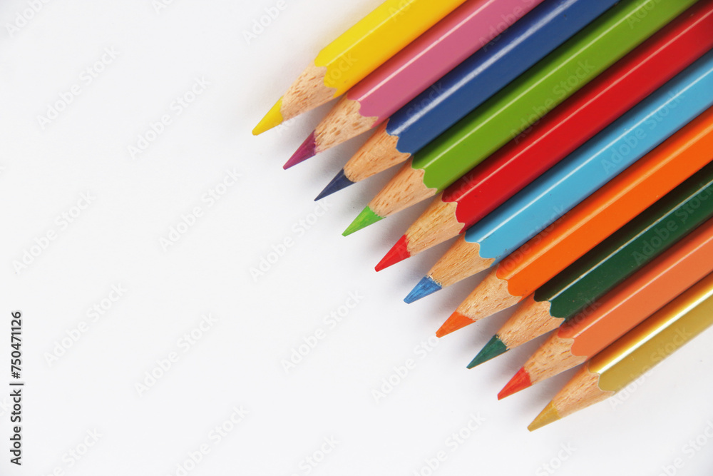 Neatly arranged colored pencils against a white background Neatly arranged colored pencils against a white background