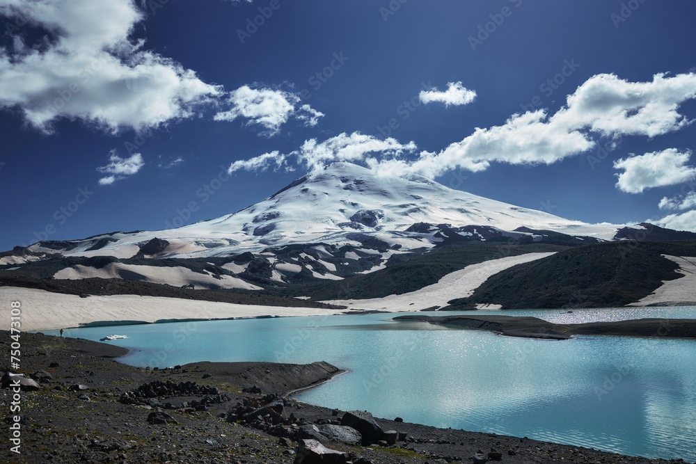 Caucasus Elbrus majestic mountain peak, blue sky lake, snow covered glacier, rocky landscape, alpine scenery Caucasus Elbrus majestic mountain peak, blue sky lake, snow covered glacier, rocky landscape, alpine scenery