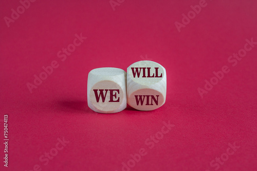 Turned a cube and changes red words we will to we win. Beautiful pink background, copy space. Business, motivational and we will win concept.