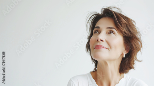 Beautiful gorgeous 50s mid aged mature woman looking at camera isolated on white.