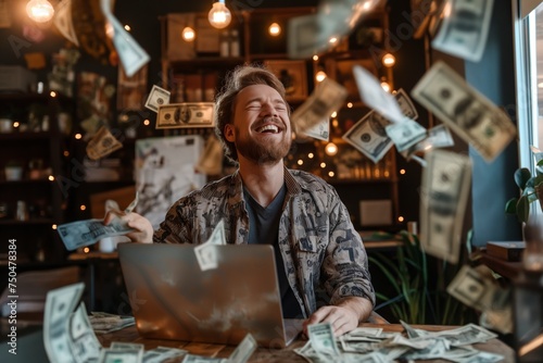 A white man sitting with a laptop surrounded by a pile of money bills.