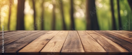 A wooden table with a view of trees in the background