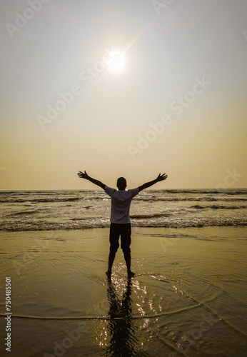 Concept of success and achievement. The boy enjoying sunrise on world largest sea beach - cox bazar. Enjoy sunrise and sea waves.