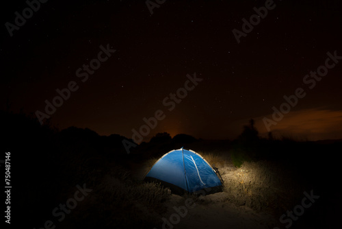 image of photographer at nighttime in a tent under starry sky 